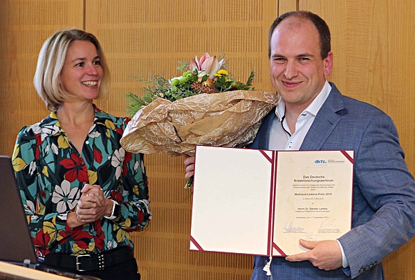 KiTZ Wissenschaftler Sander Lambo zeigt seine Auszeichnung, den Waltraud-Lewenz-Preis im Januar 2020