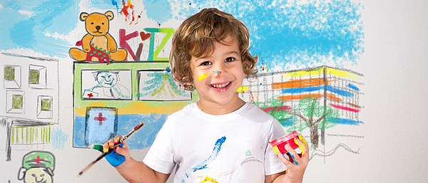 Kind mit Pinsel malt KiTZ Gebäude