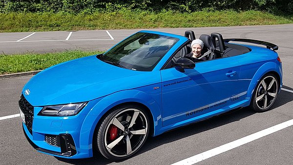 Selina in an Audi TT